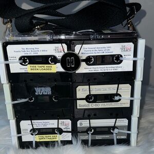 Cassette tape shoulder bag with an adjustable strap.